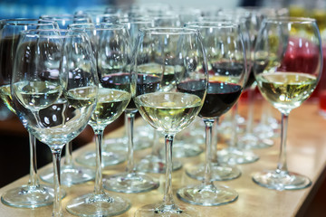 Lot of glasses with champagne and red wine.