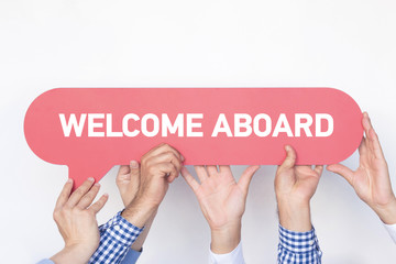 Group of people holding the WELCOME ABOARD written speech bubble