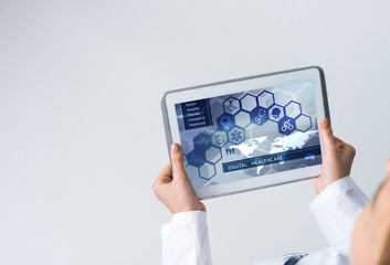 Close of female doctor hands working with tablet pc computer