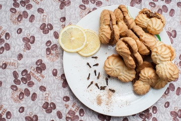 cookies on a plate with condensed milk with lemons under a coffee