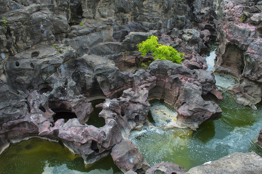 Naturally created potholes (tinajas) on the riverbed of the Kukadi River, Nighoj