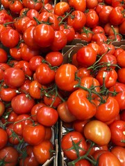 Fresh ripe tomatoes in a box on the market 