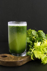 Fresh juice of celery on a black background