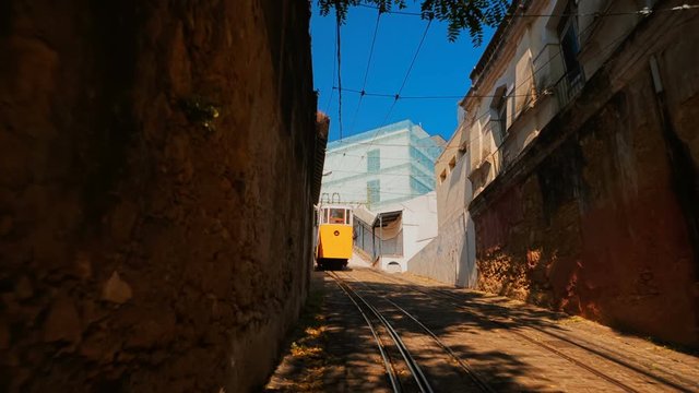 Climbing up the Calcada do Lavra to meet the famous Elevador do Lavra funicular tram streetcar, also known as Ascensor do Lavra, in Lisbon, Portugal, inaugurated in 1884