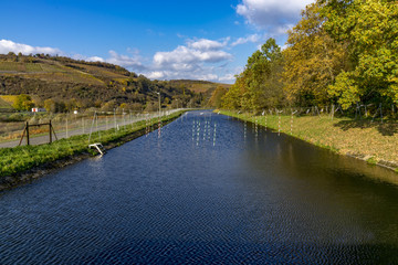 Obraz premium Straightened river with canoe sport obstacles