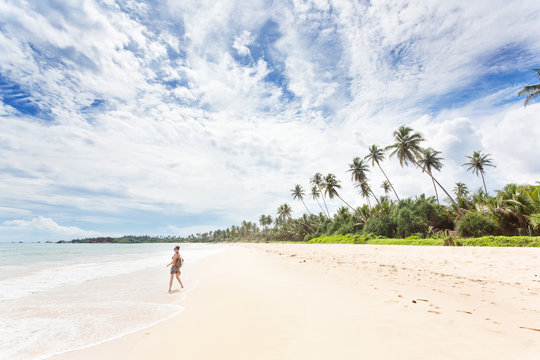 Balapitiya, Sri Lanka - A young woman enjoying nature at the beach of Balapitiya