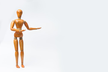 Wooden figure pose raising arm hand to introduce product for business.white isolated background