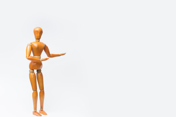 Wooden figure pose raising arm hand to introduce product for business.white isolated background