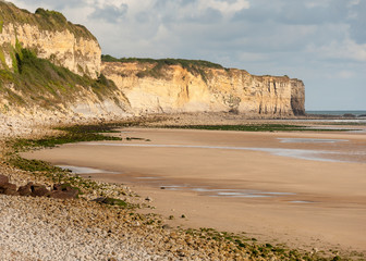 Sunrise with low clouds on Omaha Beach Normandy France