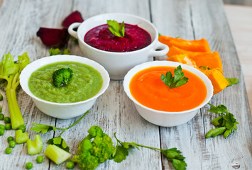 mixture of soup-puree, on a wooden background, vegetable soup in a rural style.