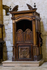 Fototapeta na wymiar Ancient confessionals, inside a Catholic church