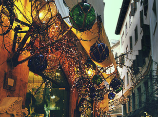 Decoration of the street. Multicolored balls and fairy christmas lights.