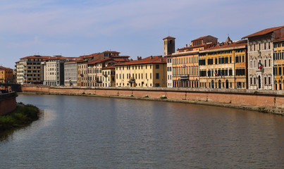 Fototapeta na wymiar Historical buildings along the Arno river in Pisa, Italy