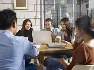 Group of young business people meeting in company