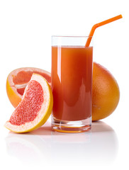 Glass of fresh grapefruit juice and cut fruits white background.