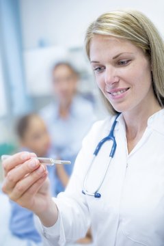Doctor looking at thermometer