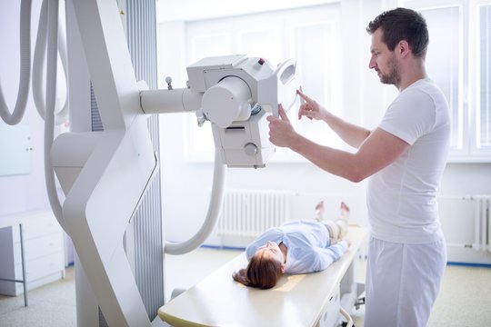 Doctor using x-ray machine on patient