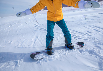 one young woman snowboarding in winter mountains