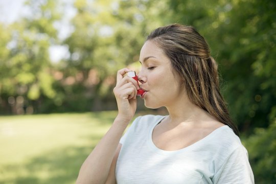 Woman using an inhaler