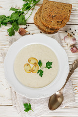 Gourmet cream soup with mushrooms (champignons), parsley and croutons. 