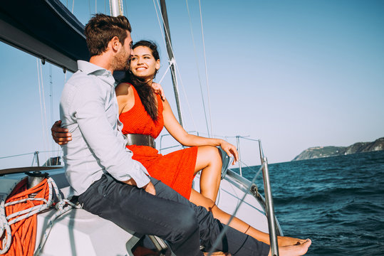 happy couple taking a romantic cruise on the sail boat