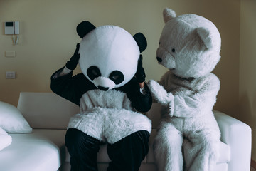 Men with animal costumes spending time inside the house