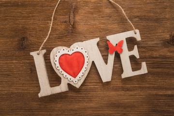 Love sign on wooden background 