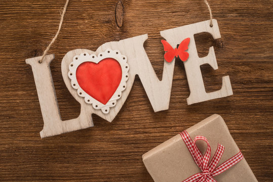 Love sign on wooden background 
