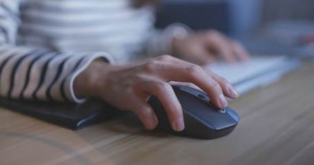 Woman using computer at night