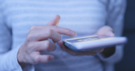 Woman use of mobile phone at night