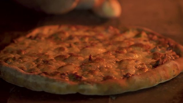 Delicious Arabic Traditional Baked Ramadan Lahmacun or Round Pide Bread with chicken egg on top cooking in rustic wood fired oven. Turkish pizza with minced beef or lamb meat, cheese and spices.