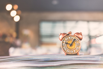 Ancient clock and stack of book