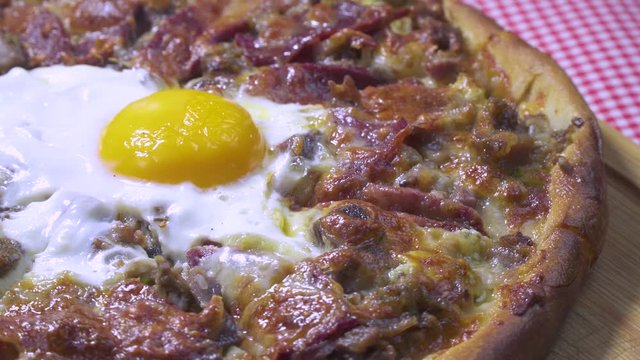 Delicious Turkish and Arabic Traditional Ramadan Food Pide, Lahmacun and Turkish Pizza serving with egg on rotating plate. Round, thin piece of dough topped with minced meat, vegetables and herbs