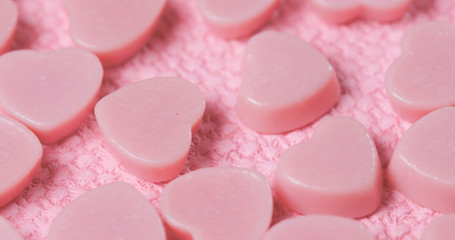 Pink chocolate candy on pink background