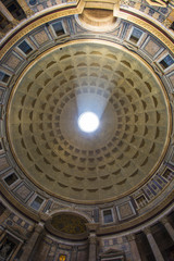Obraz premium Roman Pantheon's dome and the opening at the top called the Oculus with sun streaming through