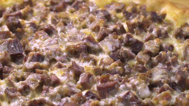 Turkish and Arabic Traditional Baked Ramadan Food Pide or Pizza ingredients with sliced halal lamb meat , butter, cheese and spicy herbs. Rotating shot