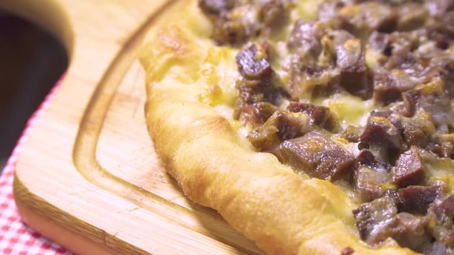 Turkish and Arabic Traditional Baked Ramadan Food Pide or Pizza ingredients with sliced halal lamb meat , butter, cheese and spicy herbs. Rotating shot. Copy space for text area.