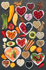 Food for a healthy heart with fruit, vegetables, fish, nuts, seeds, pulses, cereal, medicinal spices and herbs. Super food very high in omega 3, antioxidants, anthocyanins, fibre and vitamins.