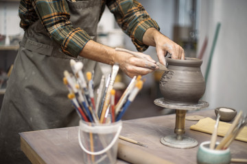 Fototapeta na wymiar Young man making pottery in workshop