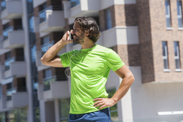 Male runner using mobile phone outdoor