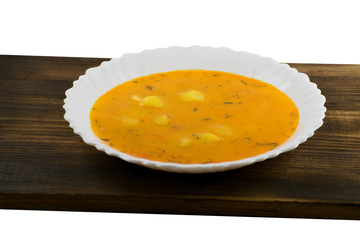 Delicious cheese cream soup on a wooden board. Pumpkin soup.