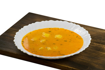 Delicious cheese cream soup on a wooden board. Pumpkin soup.