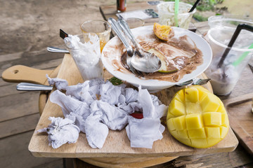 Messy table after eating dessert on the wooden table