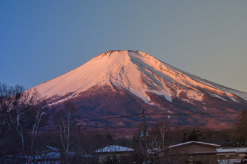 Fototapeta premium Beautiful landscape view of Fuji mountain or Mt.Fuji covered with white snow in winter seasonal at Yamanaka Lake, Japan.