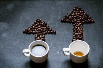 Cups of coffee under the trend line. Move up of energy. Trend up of energy. Arrow and graph. Coffee on a blackboard. Concept of energy