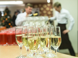 waiters pour champagne on glasses