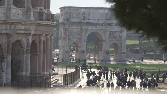  view of Colosseum and Arch of Constantine Rome with tourists
