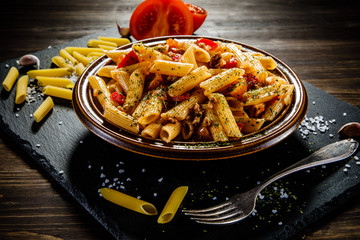 Penne with meat, tomato sauce and vegetables