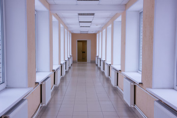 bright hospital corridor. Go to the hospital with windows, from one housing to another. Hospital transition.
