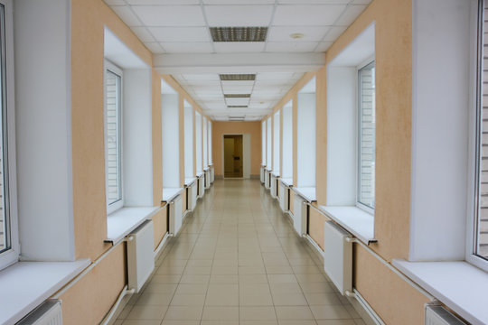 bright hospital corridor. Go to the hospital with windows, from one housing to another. Hospital transition.